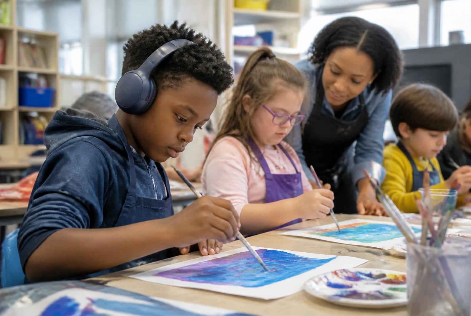 Children painting together during an inclusive enrichment program